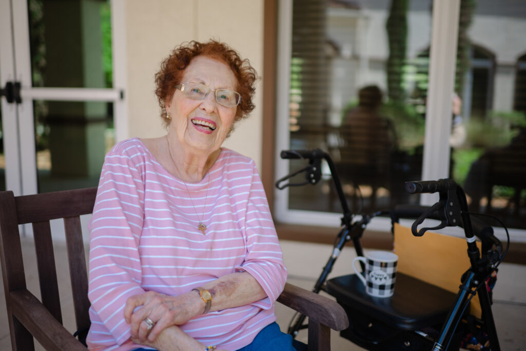 A community member at Tuscan Gardens of Palm Coast sits and enjoys the sunshine. Her life is full of opportunity even as her Alzheimer's progresses.