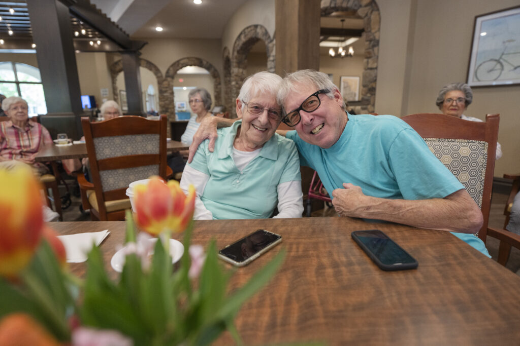 Two seniors smiling at Tuscan Gardens of Palm Coast Senior Living Community