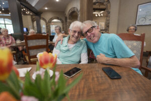 Two seniors smiling at Tuscan Gardens of Palm Coast Senior Living Community