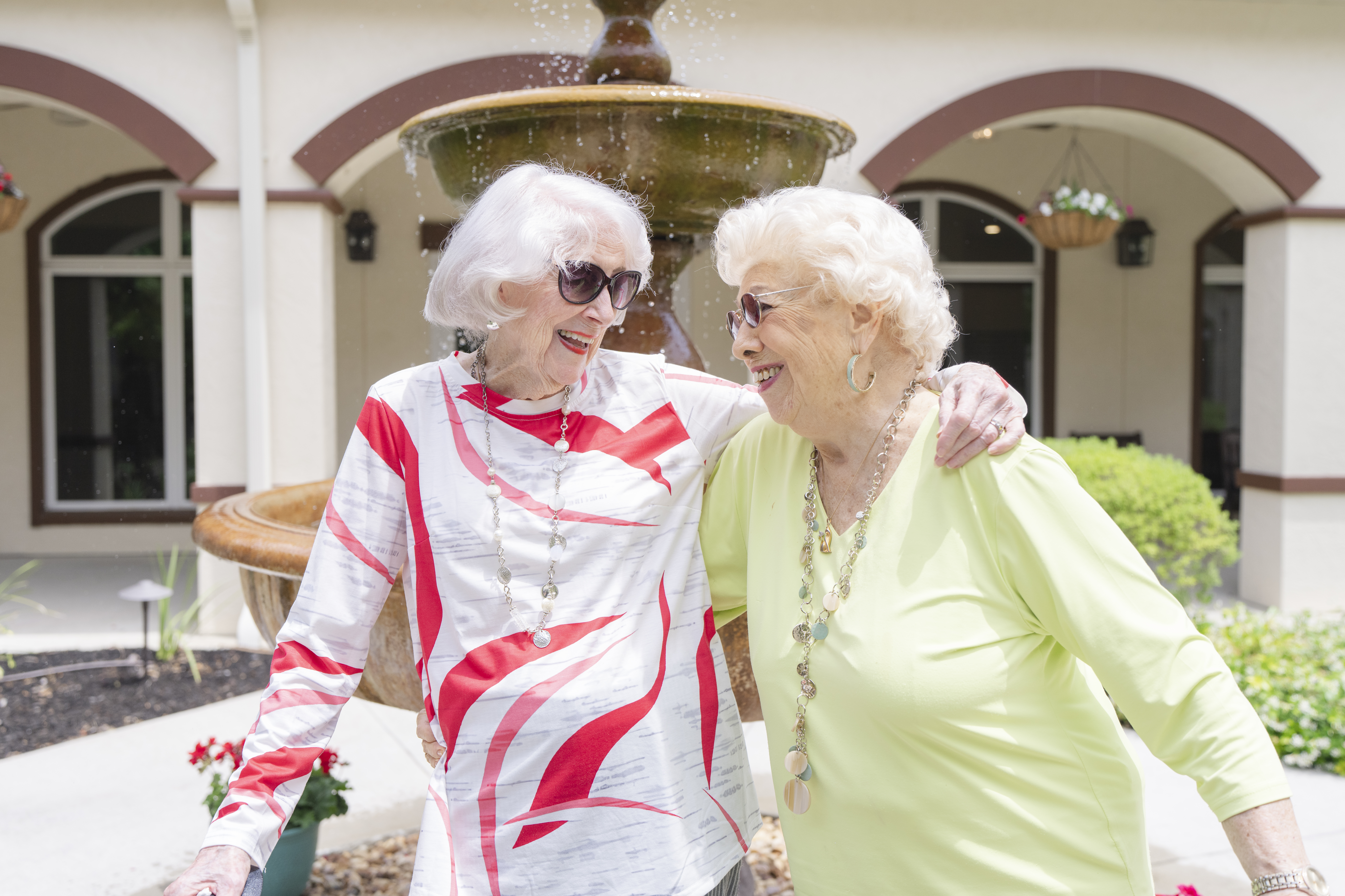 Two seniors smiling at Tuscan Gardens Senior Living Community