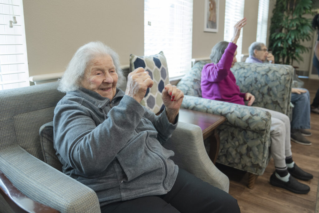 Memory care residents engage in gentle exercises and activities designed to improve balance and safety