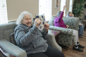 Memory care residents engage in gentle exercises and activities designed to improve balance and safety